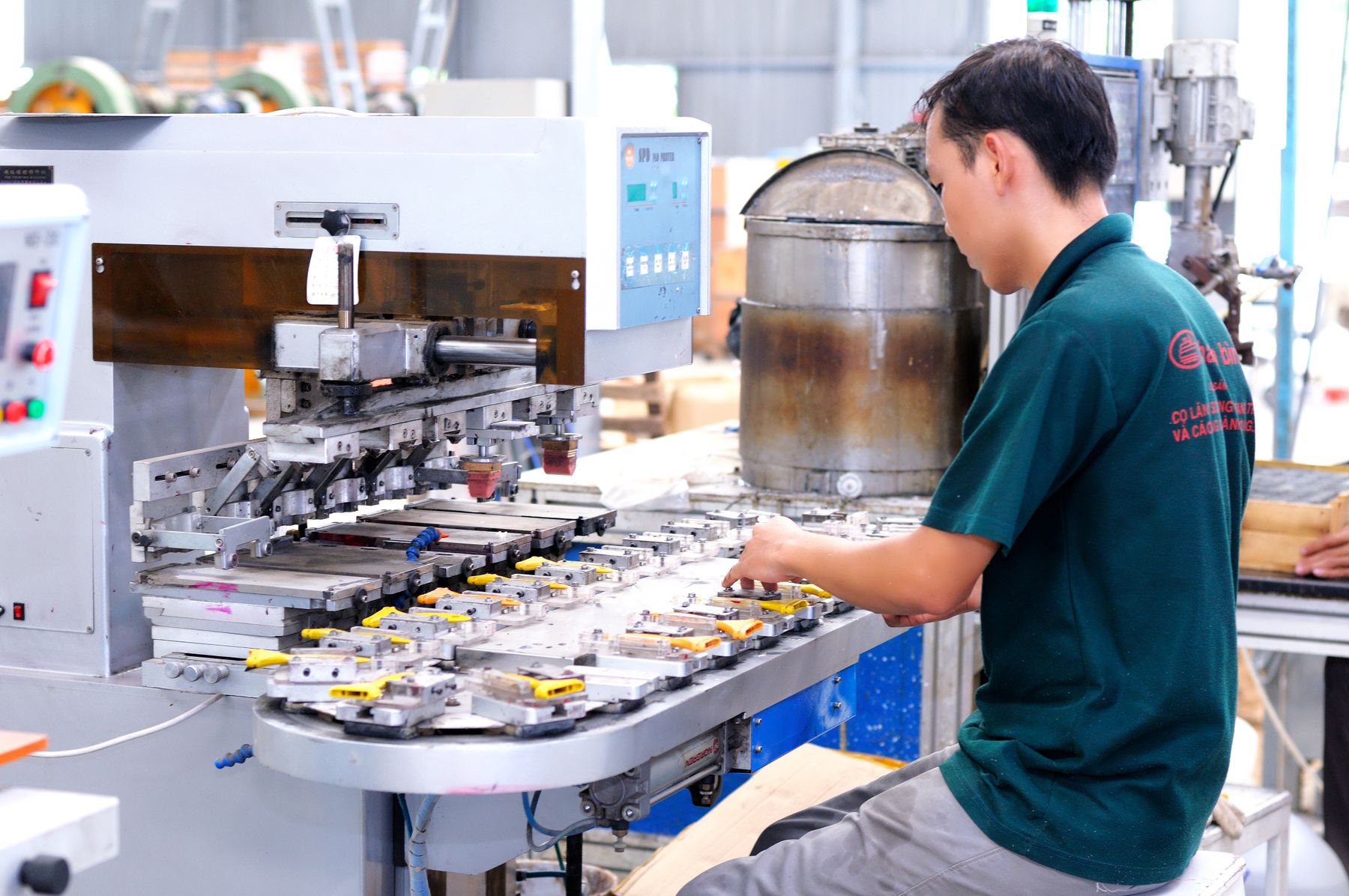 Technician operating equipment in a bright modern factory